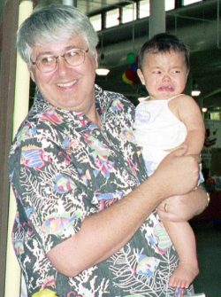 Holding a Baby at the Baby Show at the Blaisdell Center, 1999. Looks like the baby loves being held . . not. Another Satisfied Customer